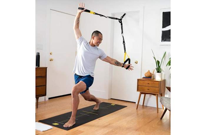 A man using TRX straps during yoga